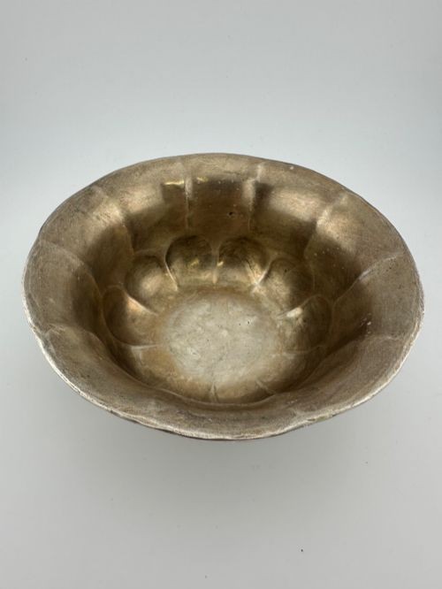 An antique Chinese export white metal footed bowl featuring chased floral patterns and bird motifs within lobed panels. View VII