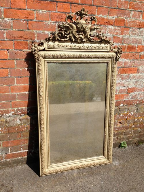 A Highly Decorative Large Antique 19th Century French Carved Wood and Gesso Mirror with Ornate Crest.