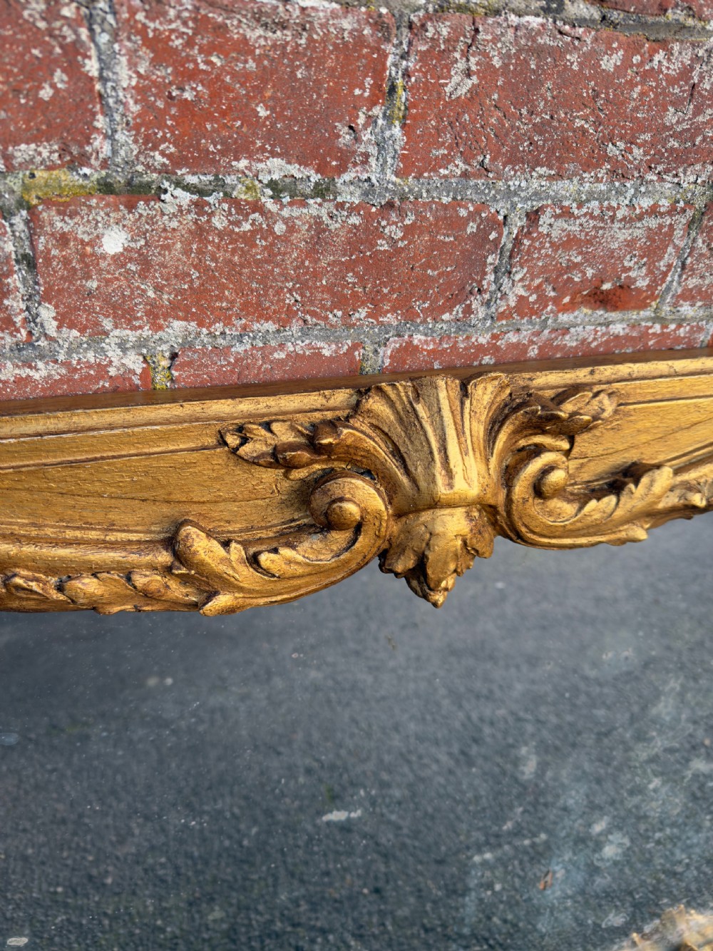 A large horizontal 19th-century overmantel mirror featuring a gilded wood and gesso frame with ornate carved acanthus leaf motifs. View II