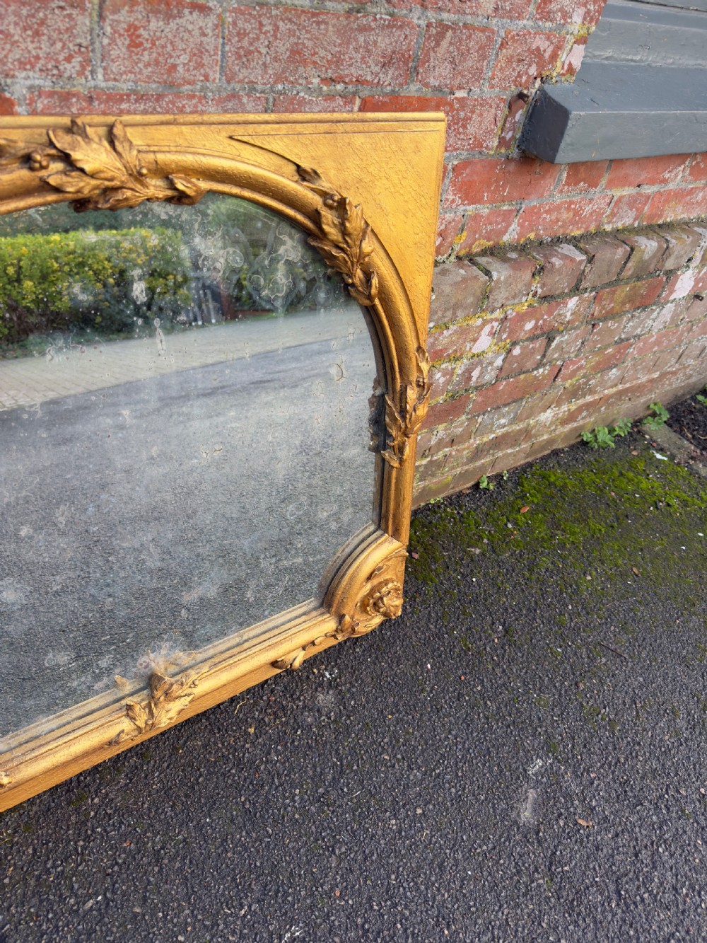 A large horizontal 19th-century overmantel mirror featuring a gilded wood and gesso frame with ornate carved acanthus leaf motifs. View III