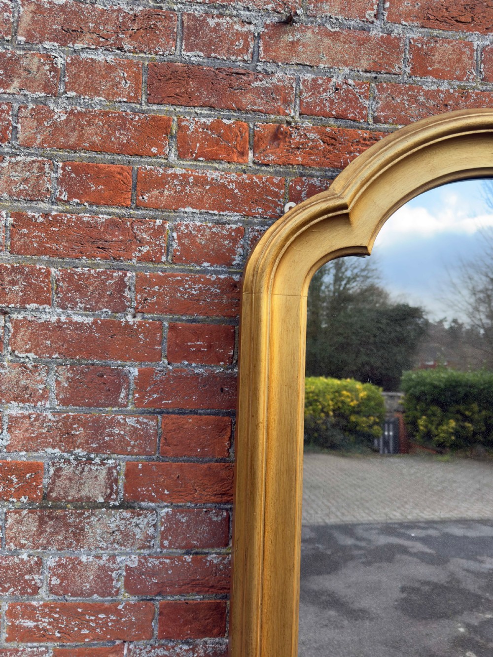 A tall 19th-century giltwood full-length mirror featuring a shaped arched top and continuous moulded frame. View V