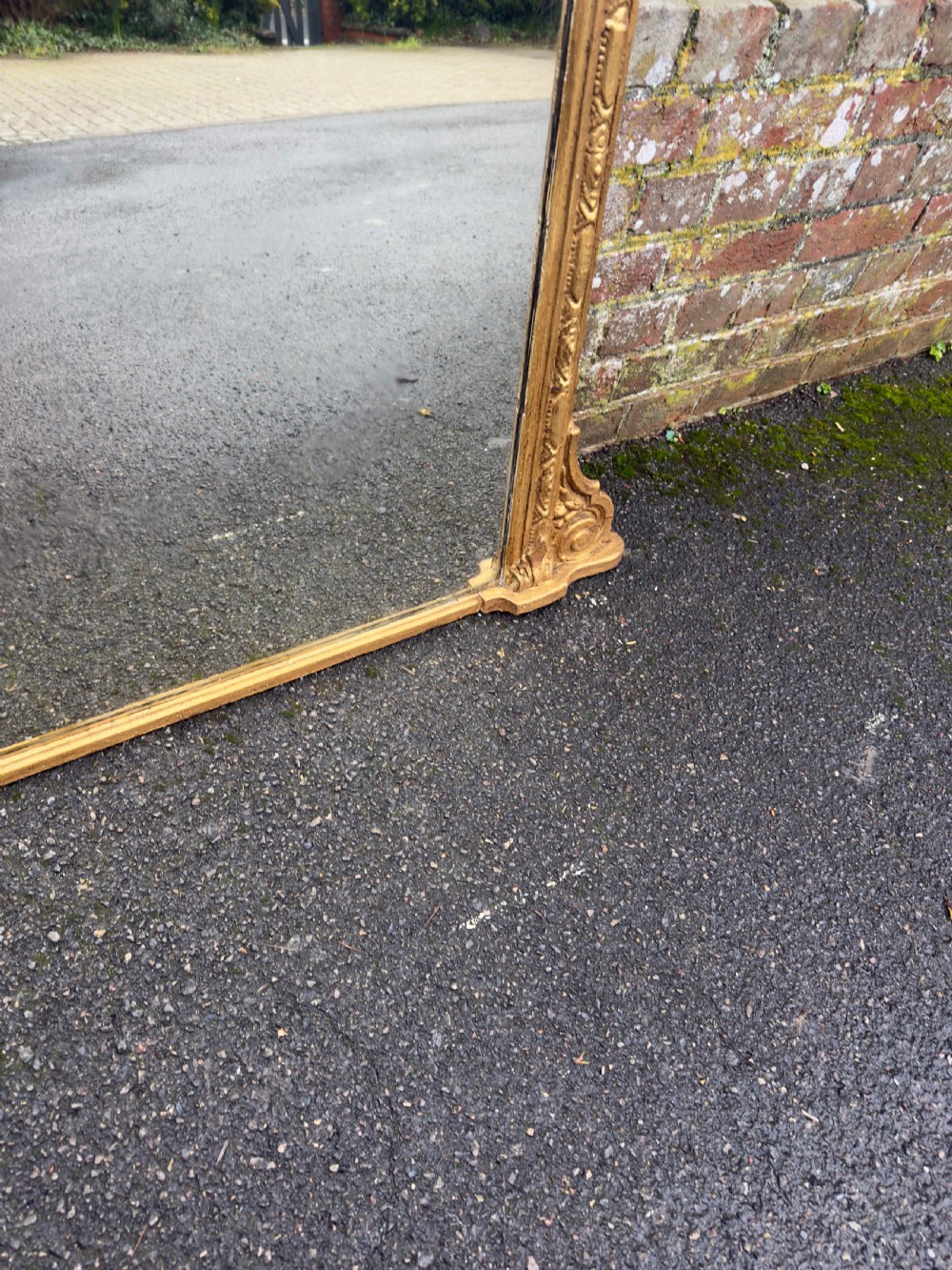 A large 19th-century rectangular overmantel mirror featuring a gilded gesso frame with floral moulding, scrolled side feet, and a stepped top cornice. View IV