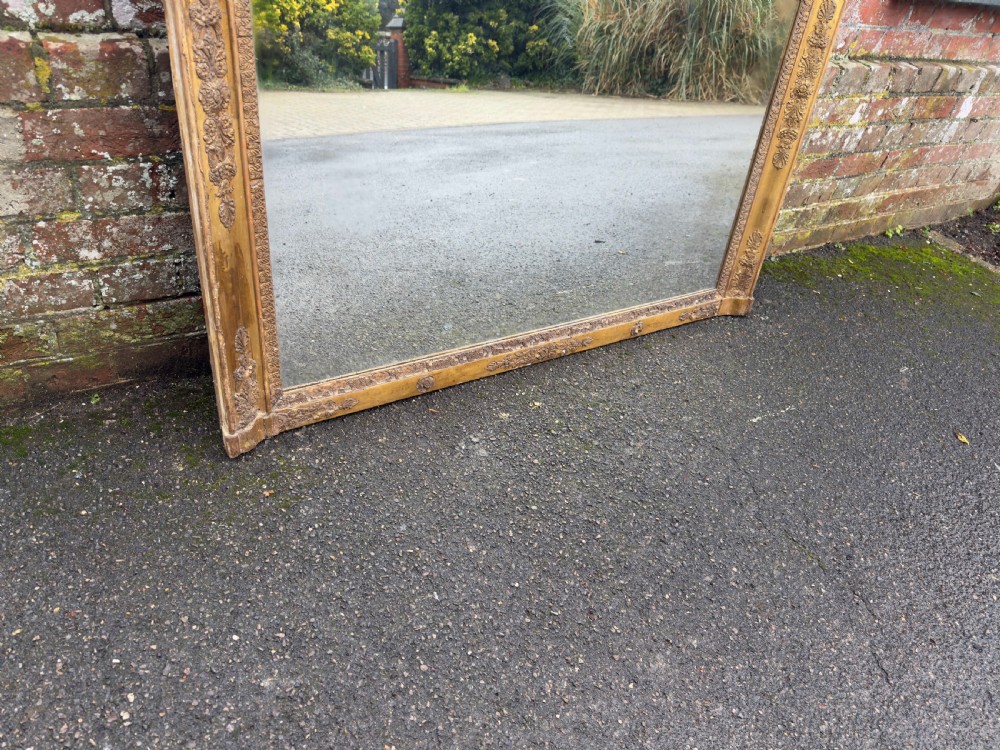 A large rectangular French 19th-century giltwood and gesso mirror featuring carved foliate mouldings and corner details. View IV