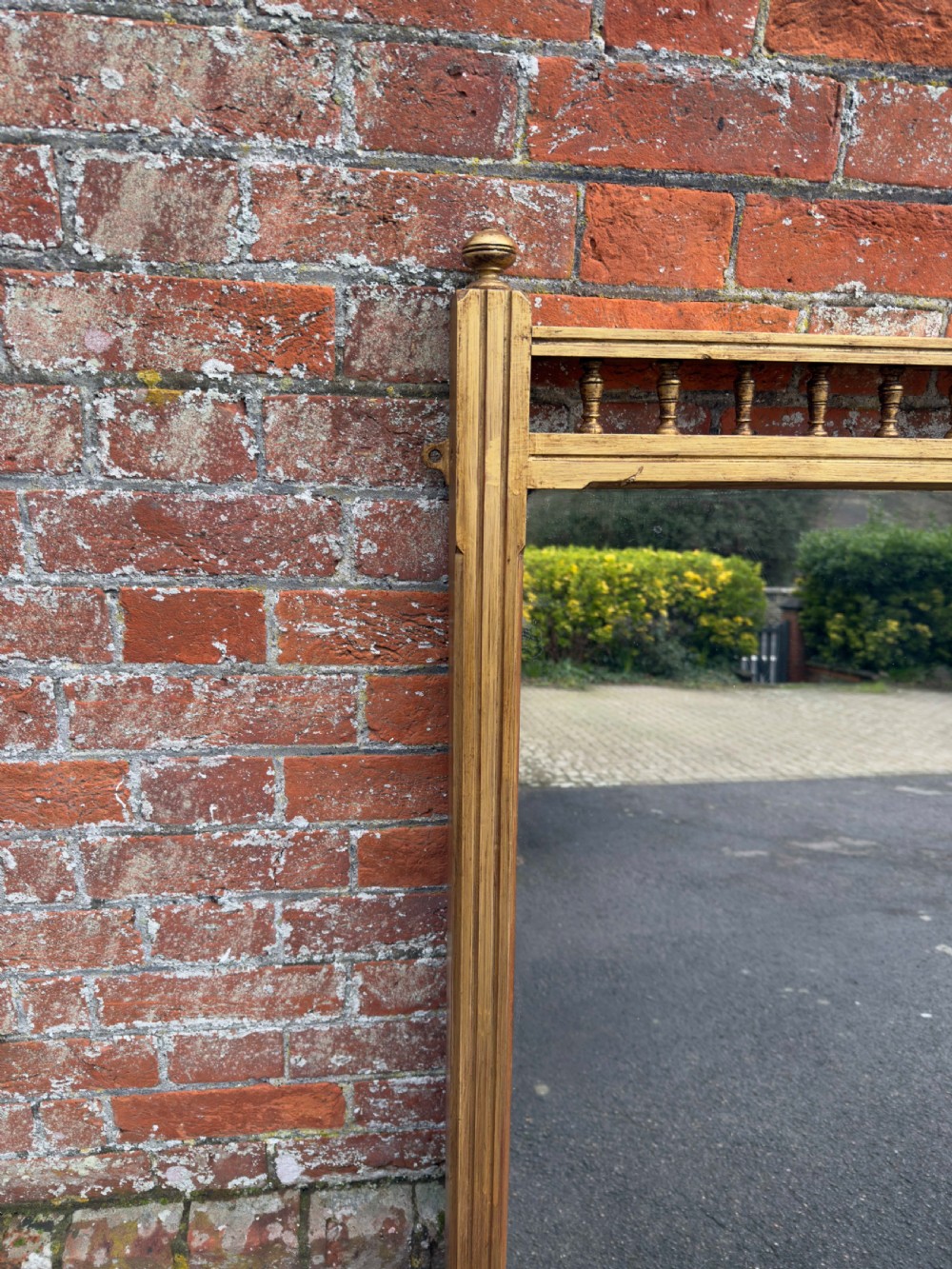 A large 19th-century rectangular gilt wood overmantel mirror featuring a upper spindle gallery and corner finials. View II