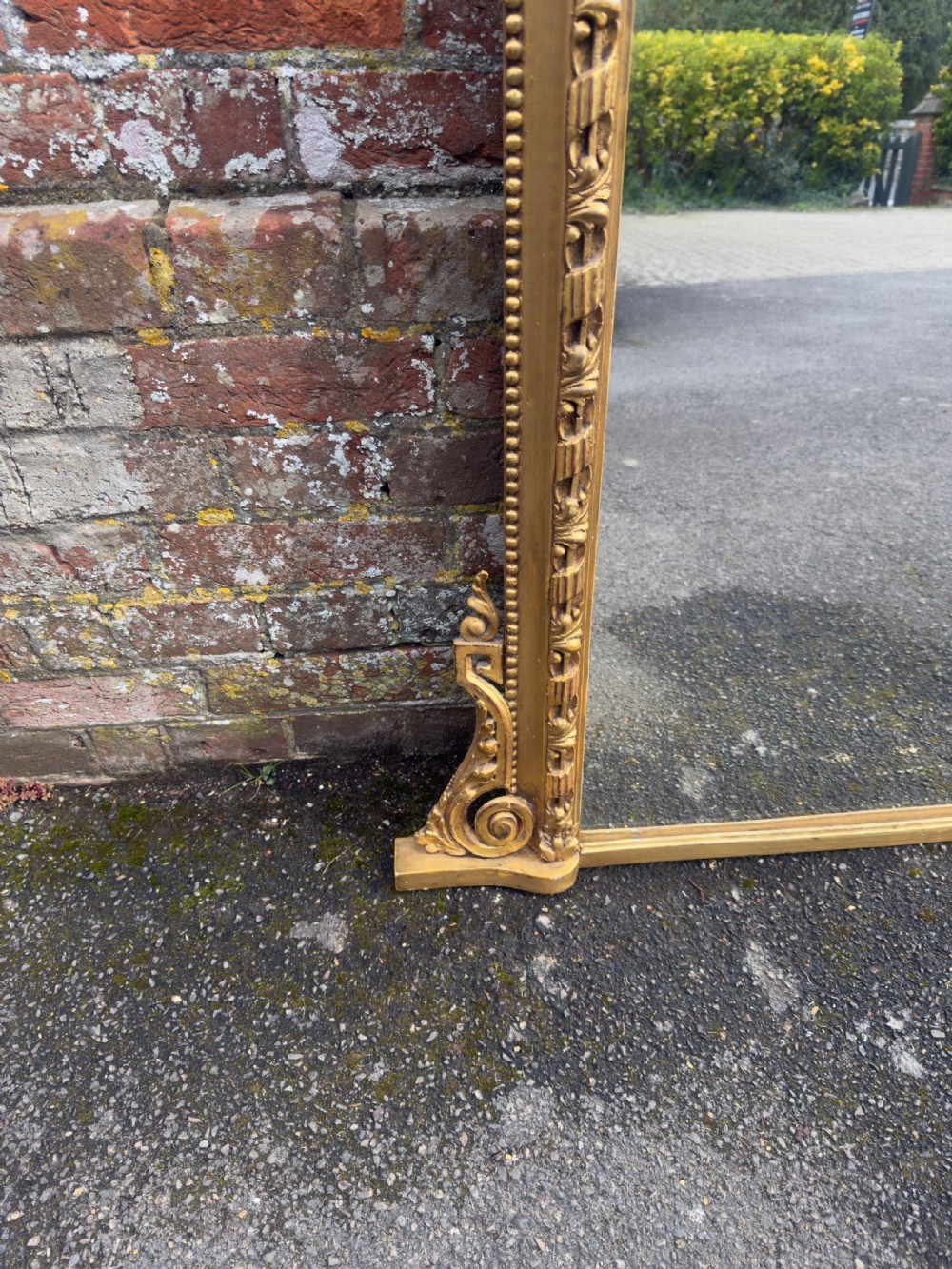 A large 19th-century rectangular giltwood and gesso overmantel mirror featuring a row of decorative spherules beneath the upper cornice and scrolled side feet. View VII
