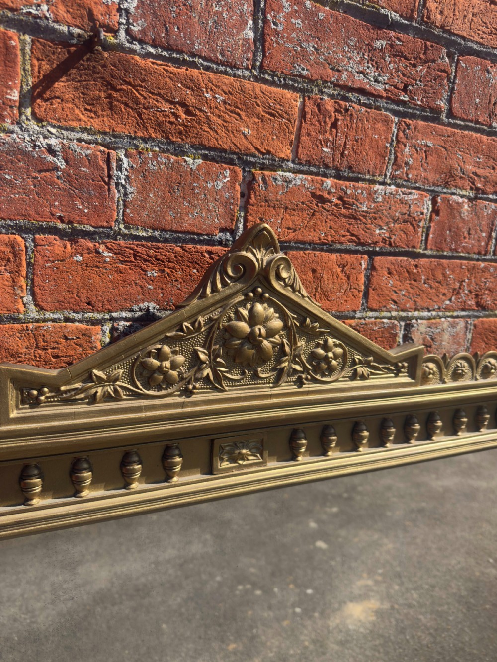 A large 19th-century rectangular giltwood overmantel mirror featuring a carved pediment with a lion mask crest and fluted side pilasters. View III
