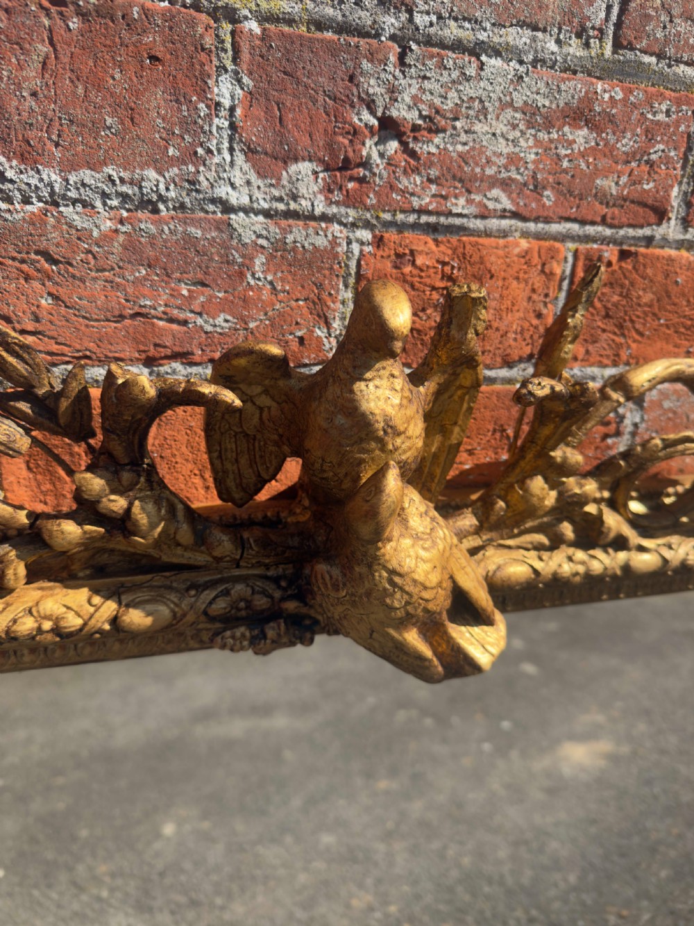 A large nineteenth-century rectangular giltwood overmantel mirror featuring ornate cresting with a bird motif and scrolled foliate moulding along the frame. View II