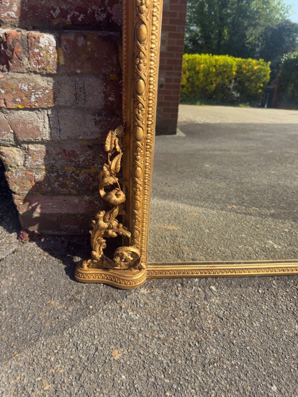A large nineteenth-century rectangular giltwood overmantel mirror featuring ornate cresting with a bird motif and scrolled foliate moulding along the frame. View VII