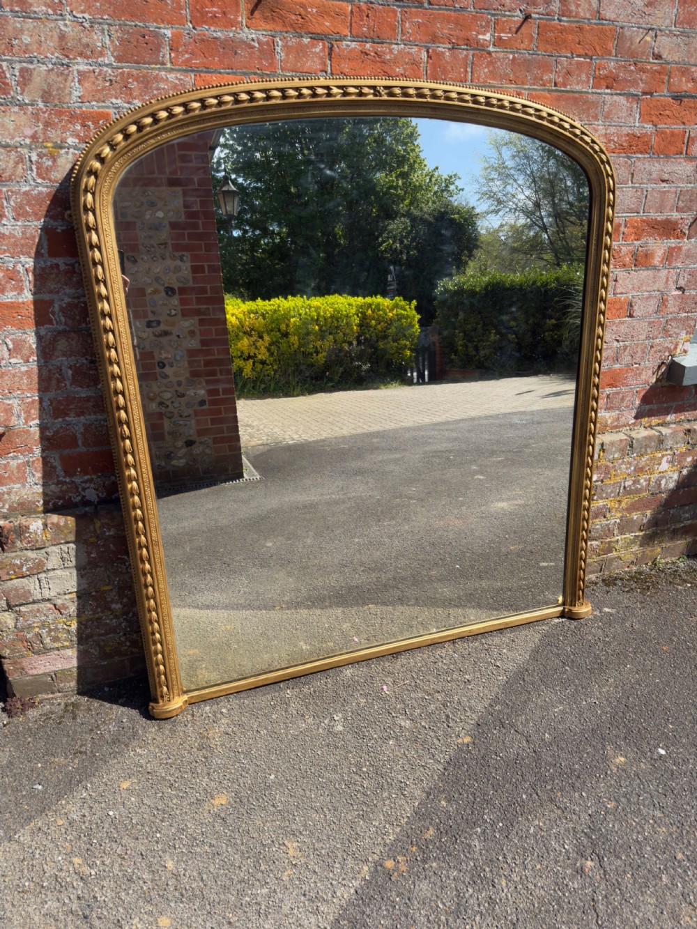 A Spectualar Large Antique English 19th Century carved wood & gesso arched top gilt Tulip framed Overmantel Mirror.