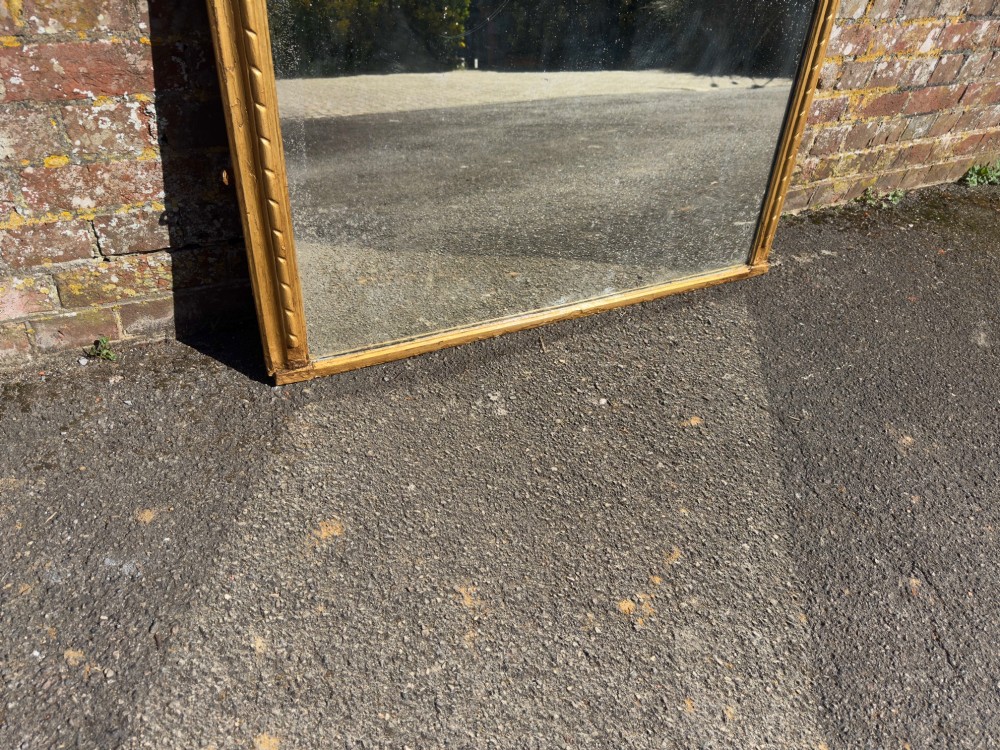 A 19th-century arched overmantel mirror featuring a gold giltwood rope-twist frame and original foxed glass. View III