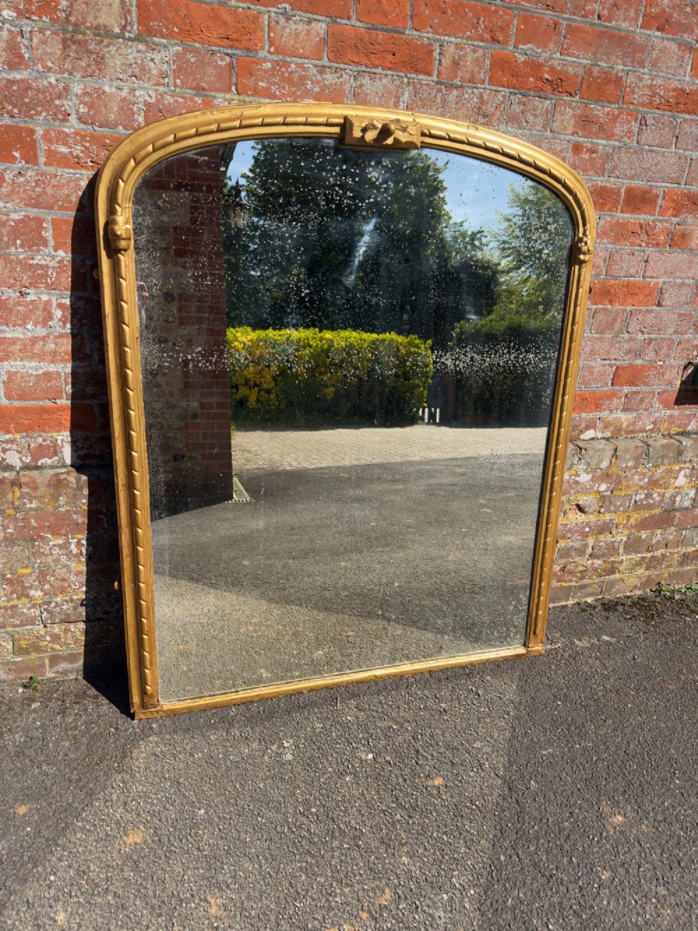 A 19th-century arched overmantel mirror featuring a gold giltwood rope-twist frame and original foxed glass. View VII