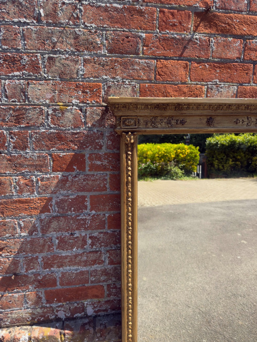 A large rectangular 19th-century giltwood overmantel mirror featuring egg-and-dart moulding along the upper frieze and scroll motifs at the lower edges. View II