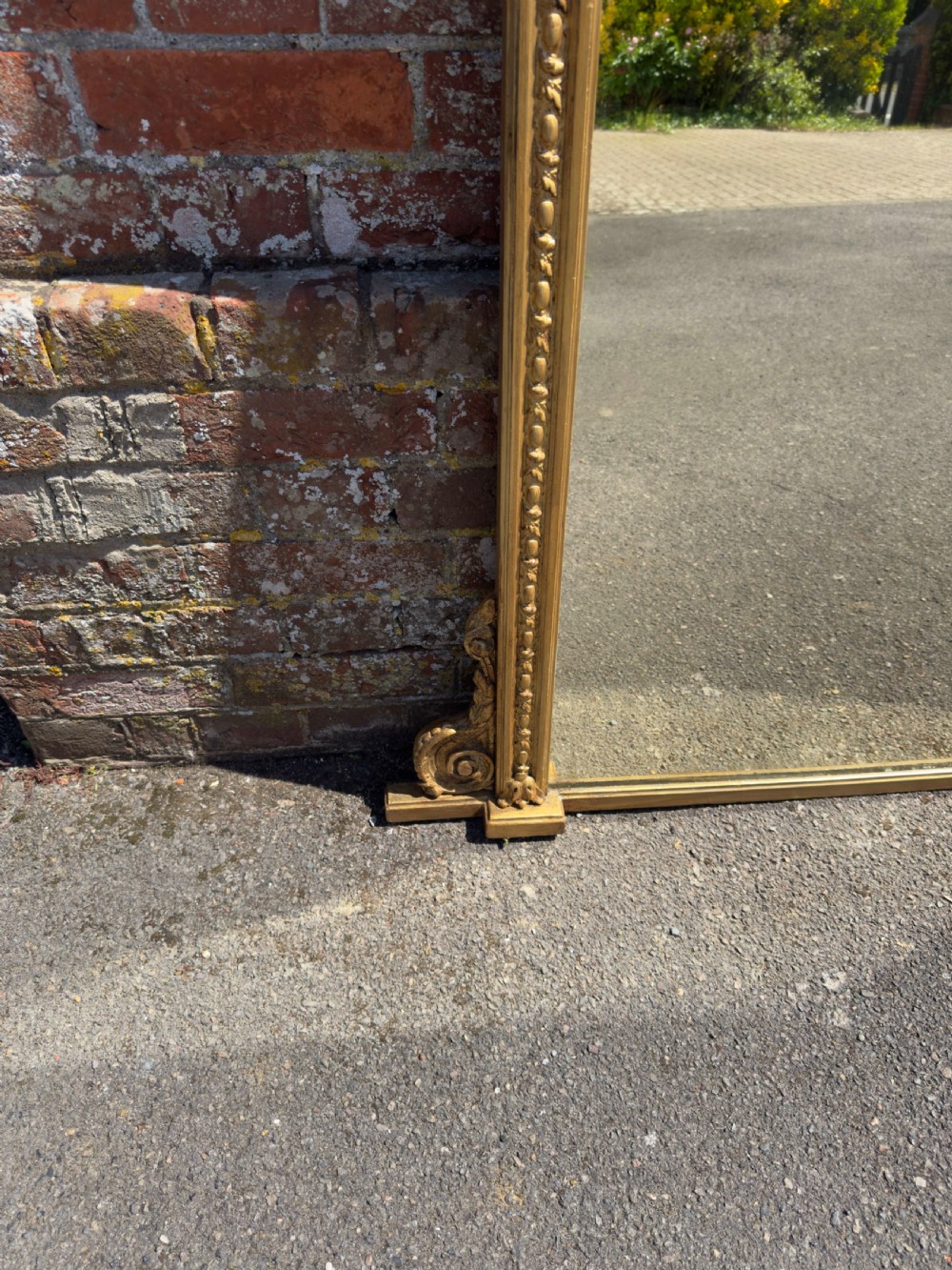 A large rectangular 19th-century giltwood overmantel mirror featuring egg-and-dart moulding along the upper frieze and scroll motifs at the lower edges. View IV