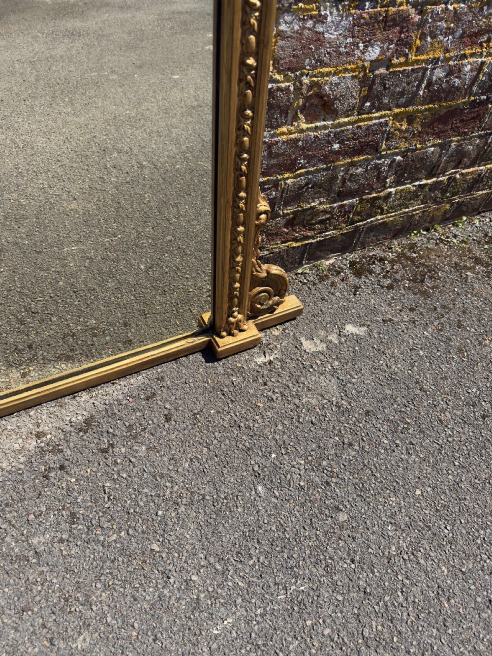 A large rectangular 19th-century giltwood overmantel mirror featuring egg-and-dart moulding along the upper frieze and scroll motifs at the lower edges. View V