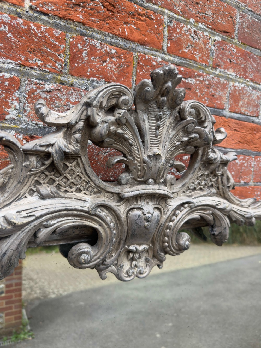 A tall 19th-century French arched mirror with a carved foliate gesso crest and aged silver leaf finish. View II