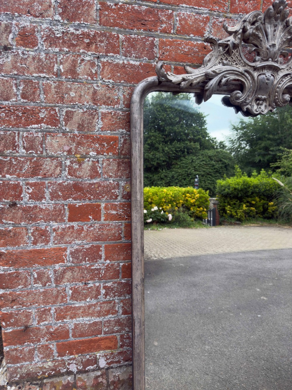 A tall 19th-century French arched mirror with a carved foliate gesso crest and aged silver leaf finish. View IV