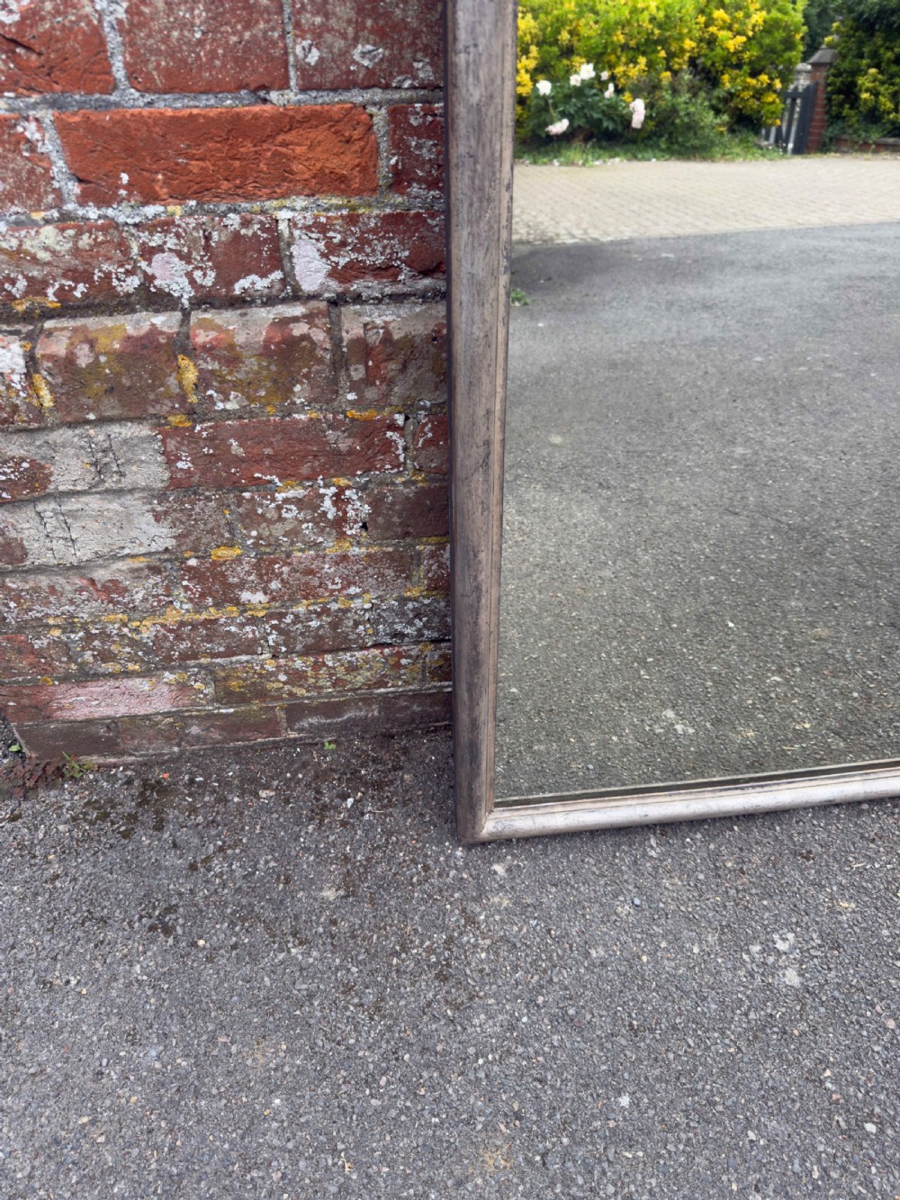 A tall 19th-century French arched mirror with a carved foliate gesso crest and aged silver leaf finish. View V