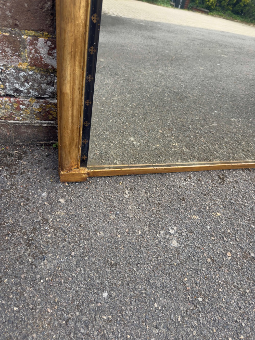A large Victorian arched overmantel mirror featuring a gilded wood frame with a dark inner border detailing. View V