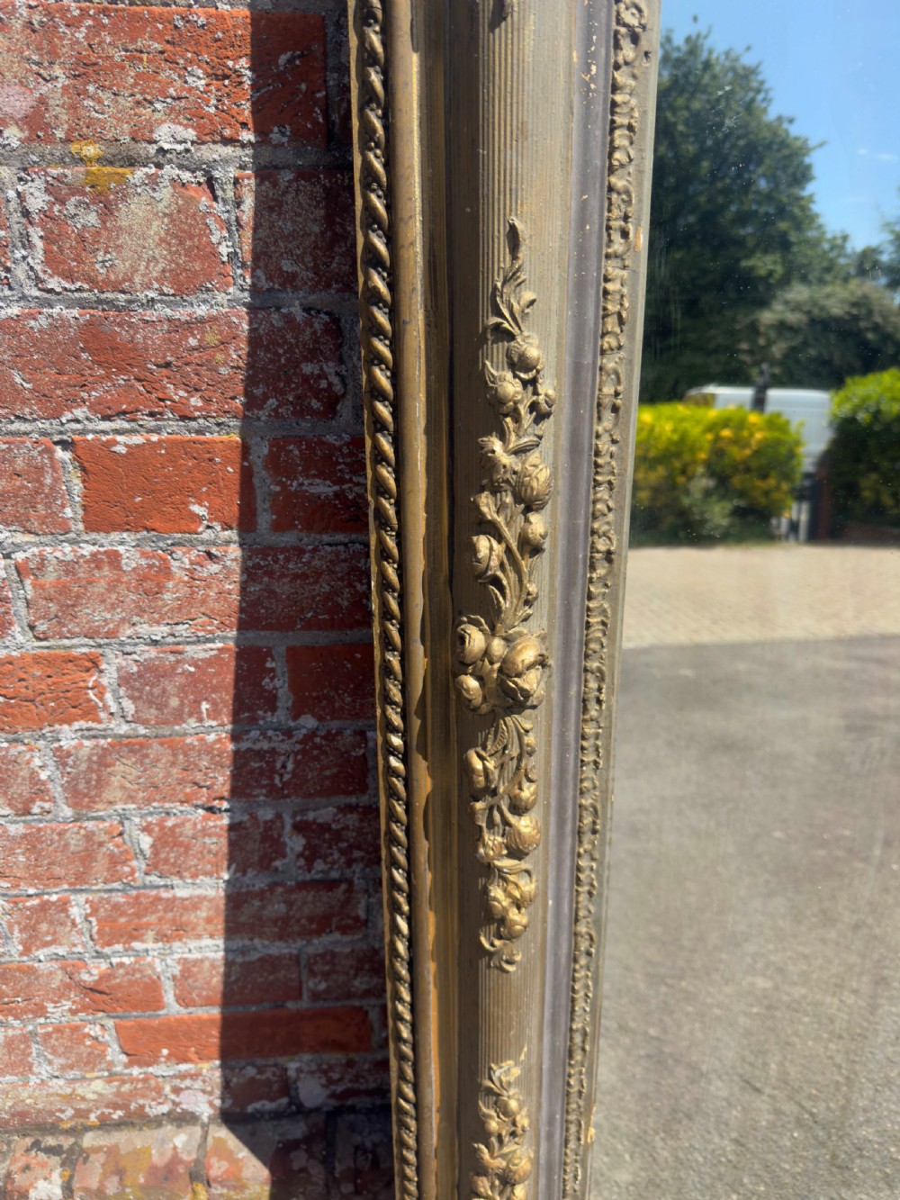 A large 19th-century rectangular French mirror featuring an ornate gilded gesso frame with detailed floral and leaf mouldings. View V