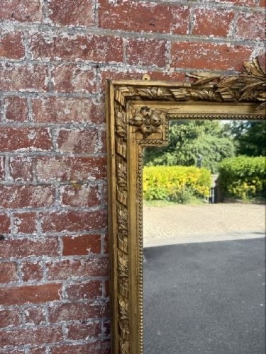 A large 19th-century French rectangular mirror featuring a carved gold leaf frame adorned with a rope twist border and a decorative foliage crest. View VI