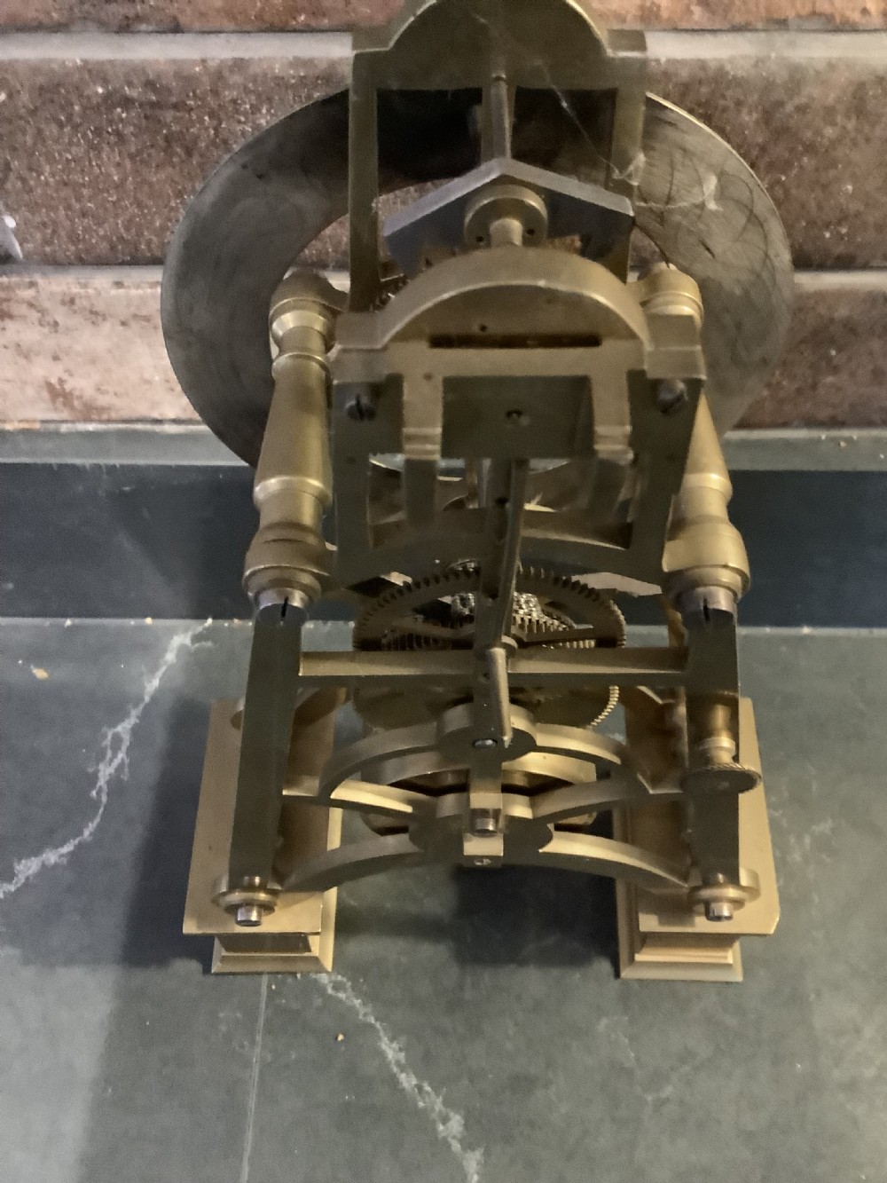 A Victorian patinated bronze mantel clock featuring an open skeleton dial signed Frodsham Gracechurch Street alongside a brass pendulum and winding key. View V
