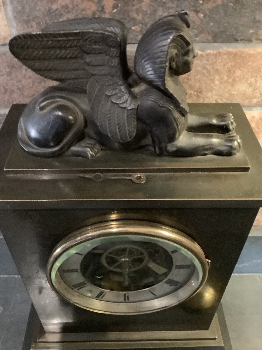 A Victorian patinated bronze mantel clock featuring an open skeleton dial signed Frodsham Gracechurch Street alongside a brass pendulum and winding key. View VI
