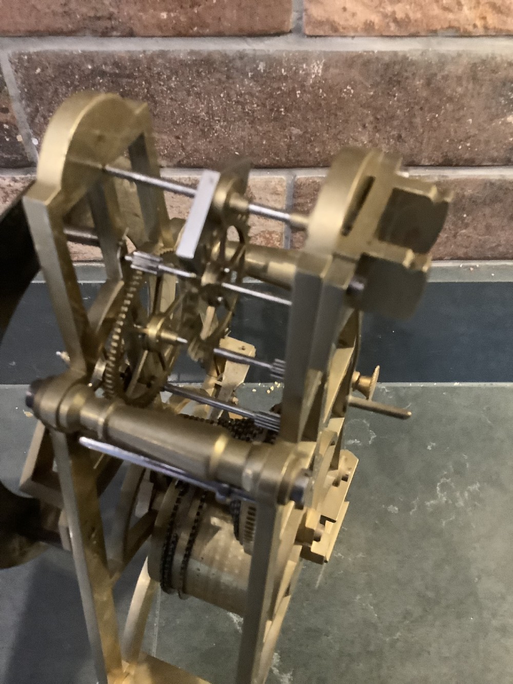 A Victorian patinated bronze mantel clock featuring an open skeleton dial signed Frodsham Gracechurch Street alongside a brass pendulum and winding key. View IX