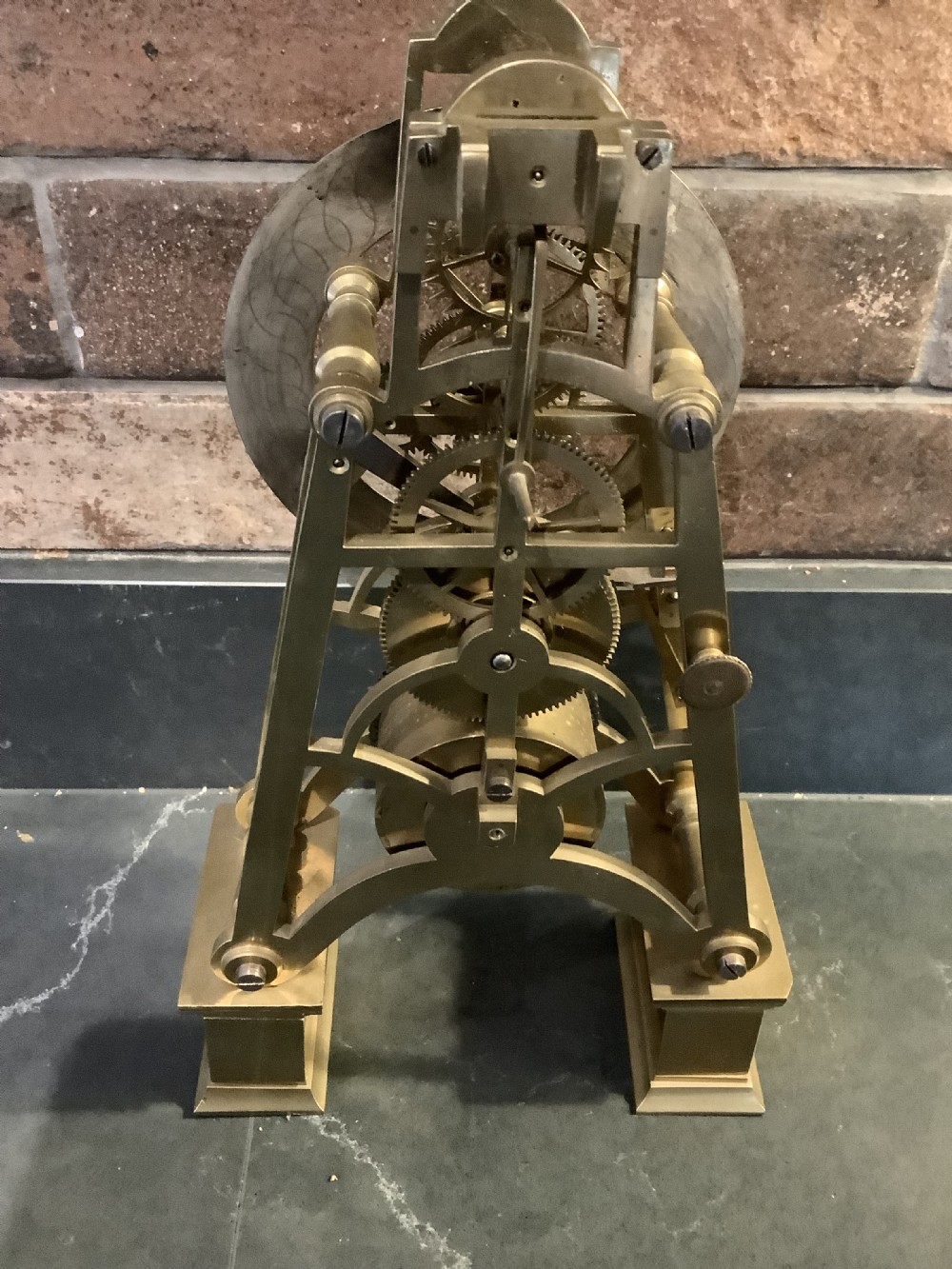 A Victorian patinated bronze mantel clock featuring an open skeleton dial signed Frodsham Gracechurch Street alongside a brass pendulum and winding key. View X