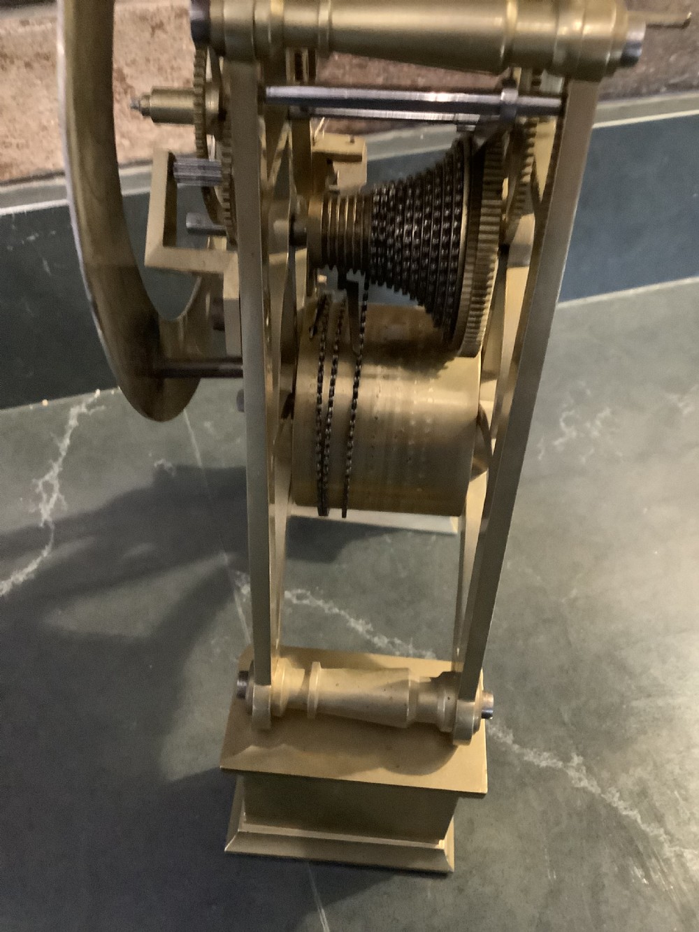 A Victorian patinated bronze mantel clock featuring an open skeleton dial signed Frodsham Gracechurch Street alongside a brass pendulum and winding key. View XI