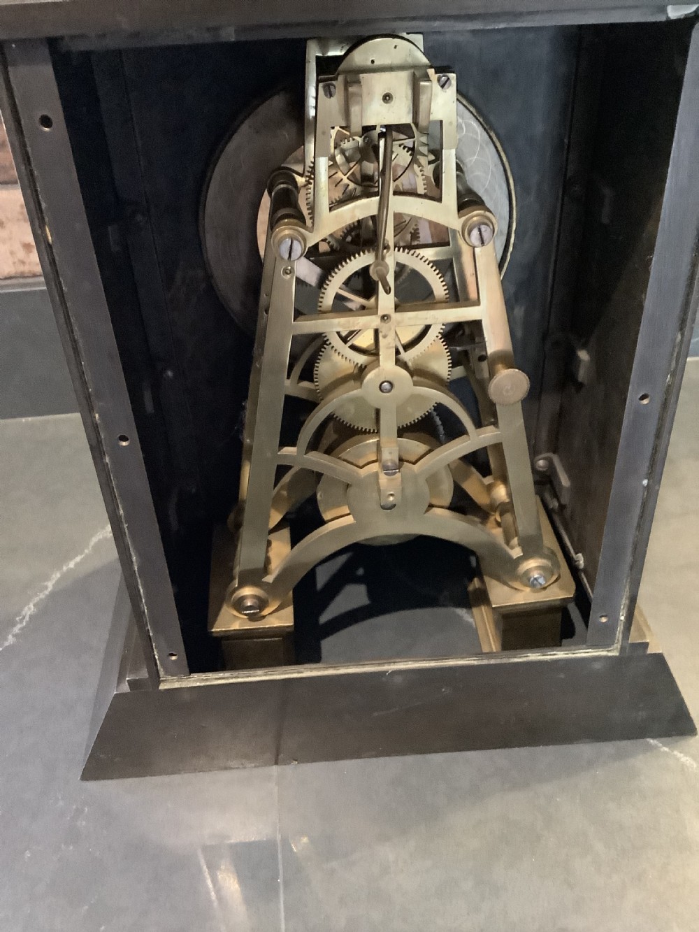 A Victorian patinated bronze mantel clock featuring an open skeleton dial signed Frodsham Gracechurch Street alongside a brass pendulum and winding key. View XV