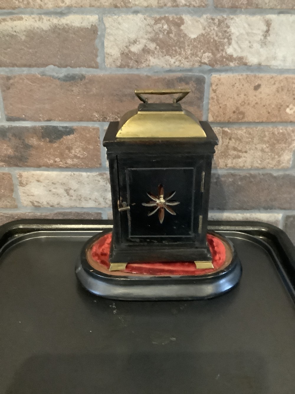 A nineteenth-century French striking mantel clock set within a dark wood and brass-trimmed case with a white enamel dial displaying Roman numerals. View II