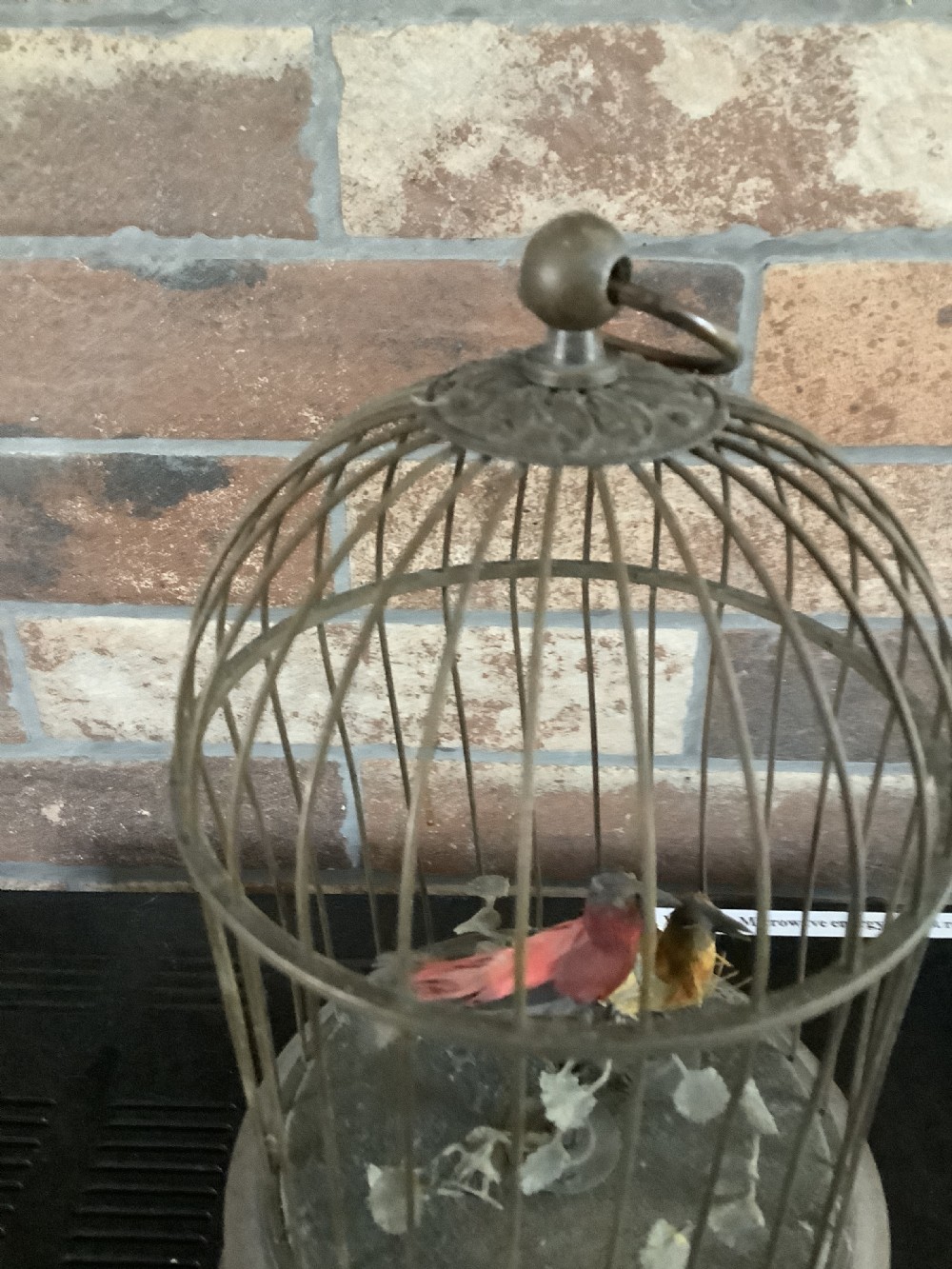 An antique brass domed birdcage automaton featuring two artificial feathered birds perched inside on an ornate base. View VI