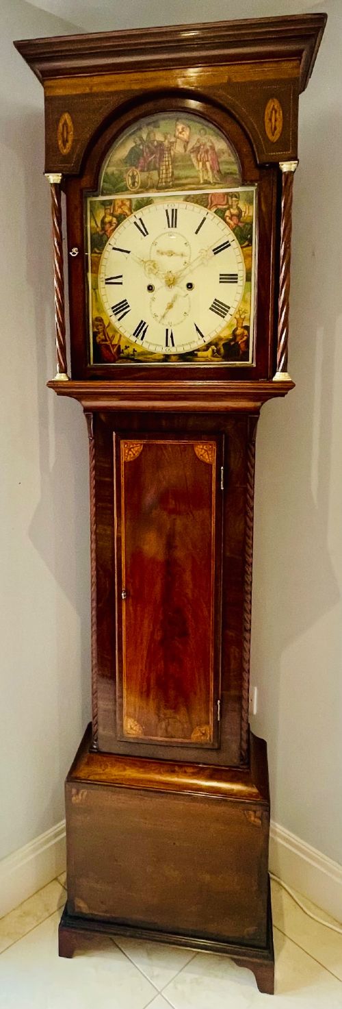 fig 1. An antique Scottish Georgian mahogany longcase clock featuring a hand-painted dial, spiral turned columns, and marquetry inlay.