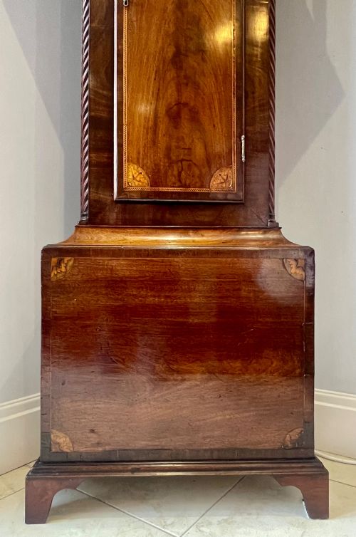 fig 4. An antique Scottish Georgian mahogany longcase clock featuring a hand-painted dial, spiral turned columns, and marquetry inlay.