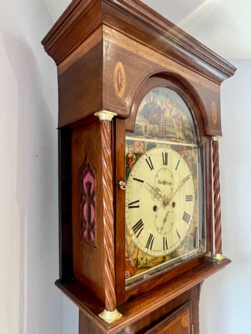 fig 6. An antique Scottish Georgian mahogany longcase clock featuring a hand-painted dial, spiral turned columns, and marquetry inlay.