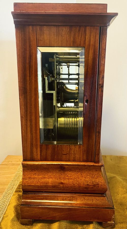 fig 4. A Victorian mahogany four-glass bracket clock featuring a white dial with Roman numerals and a moulded stepped base.