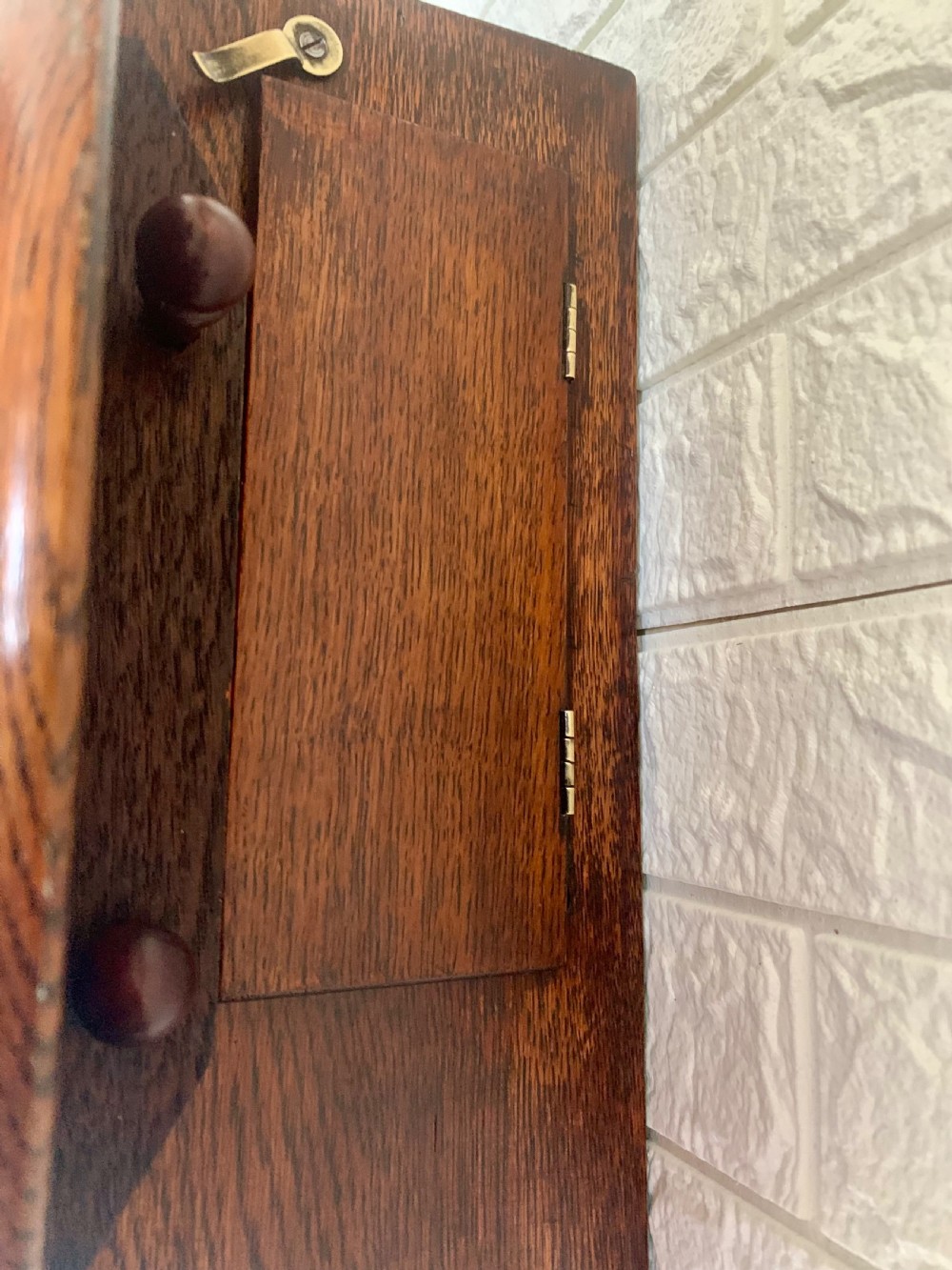 A circular wooden wall clock with a white dial, Roman numerals, black hands, and official G.P.O. markings set within a brass bezel. View X