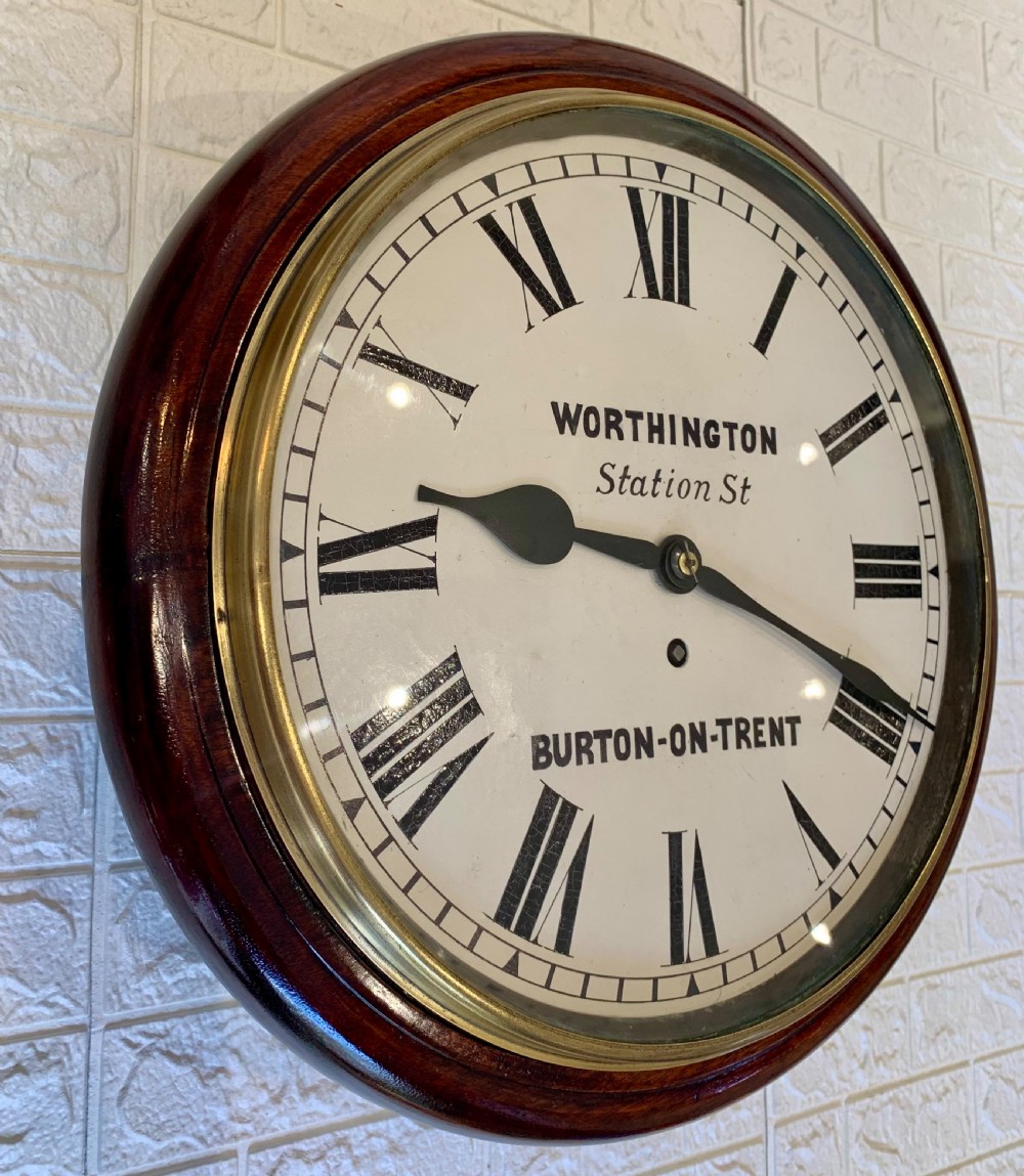 A circular Victorian mahogany fusee dial wall clock featuring a brass bezel and white face with Roman numerals. View II