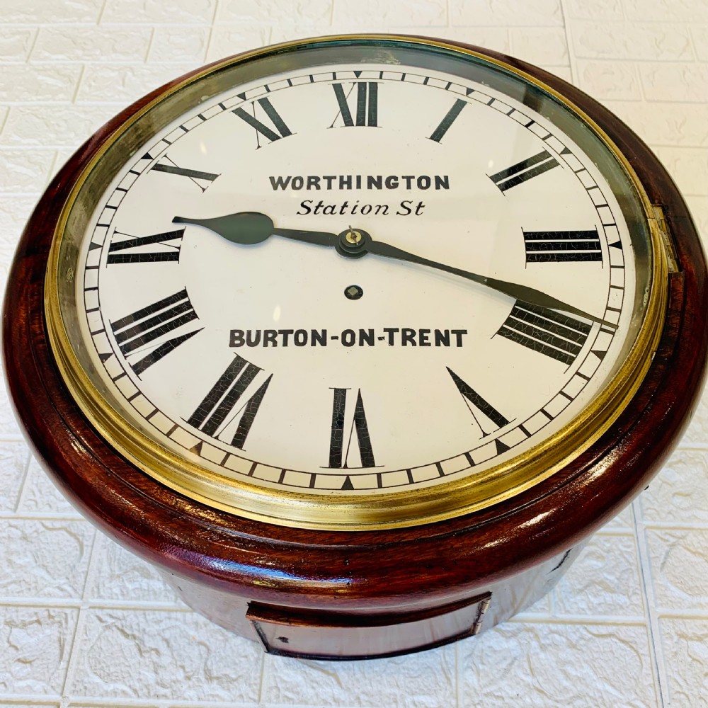 A circular Victorian mahogany fusee dial wall clock featuring a brass bezel and white face with Roman numerals. View III