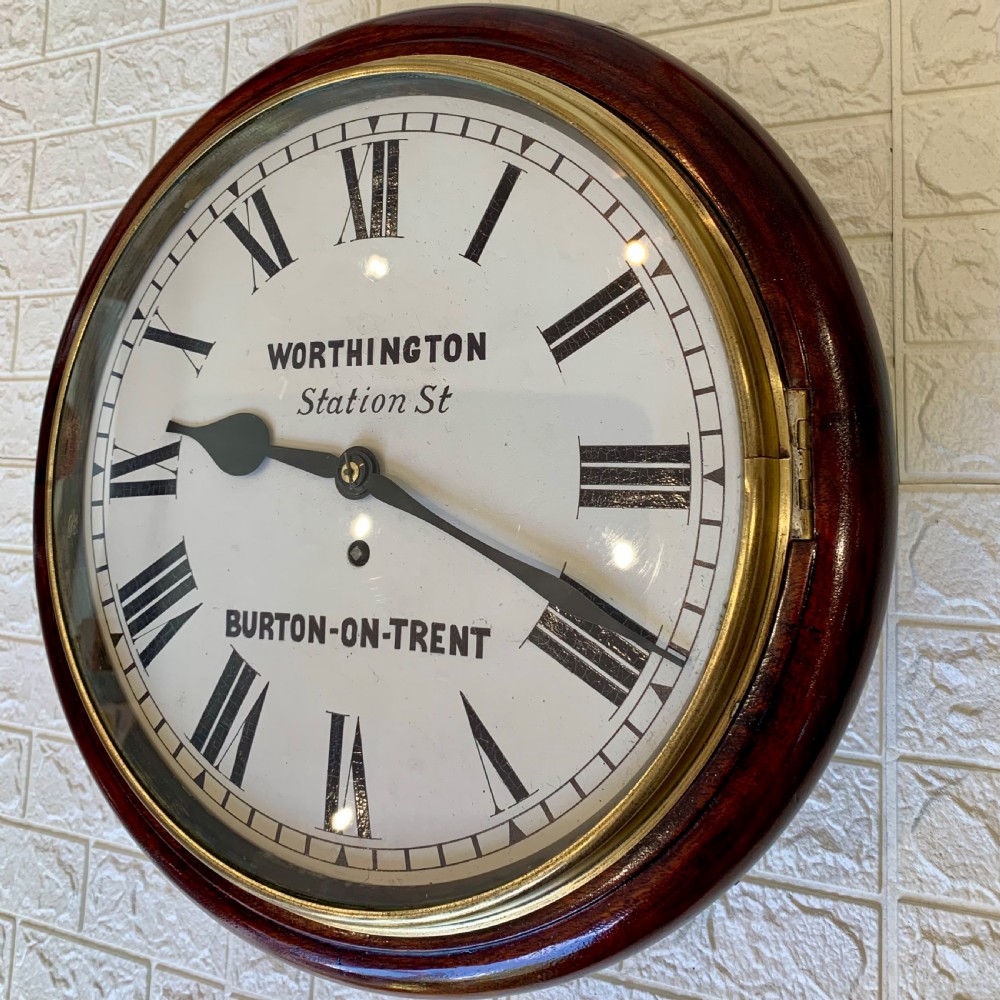 A circular Victorian mahogany fusee dial wall clock featuring a brass bezel and white face with Roman numerals. View IV