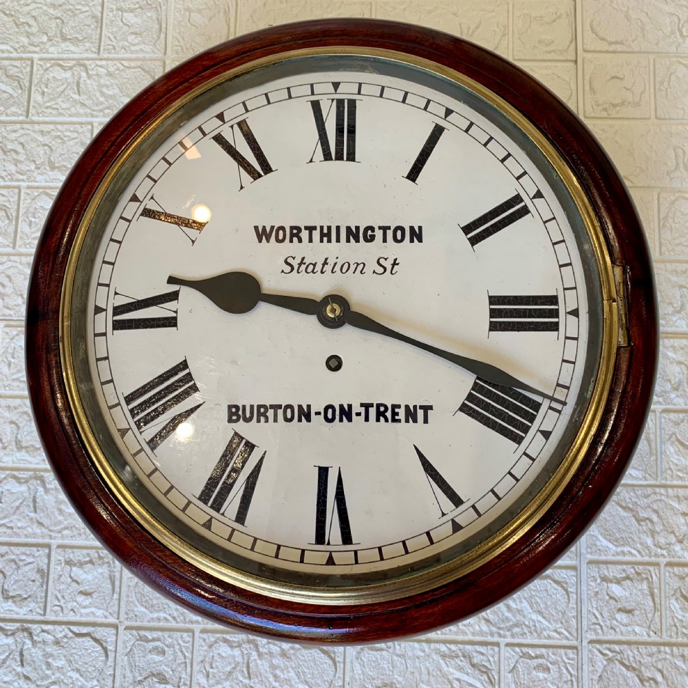 A circular Victorian mahogany fusee dial wall clock featuring a brass bezel and white face with Roman numerals. View V