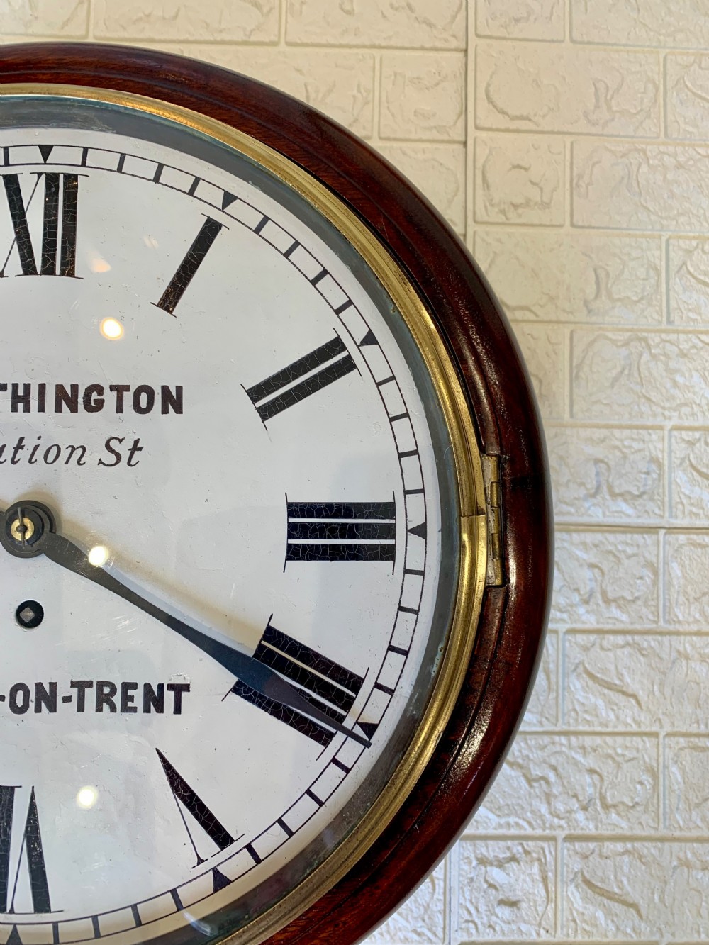 A circular Victorian mahogany fusee dial wall clock featuring a brass bezel and white face with Roman numerals. View VII