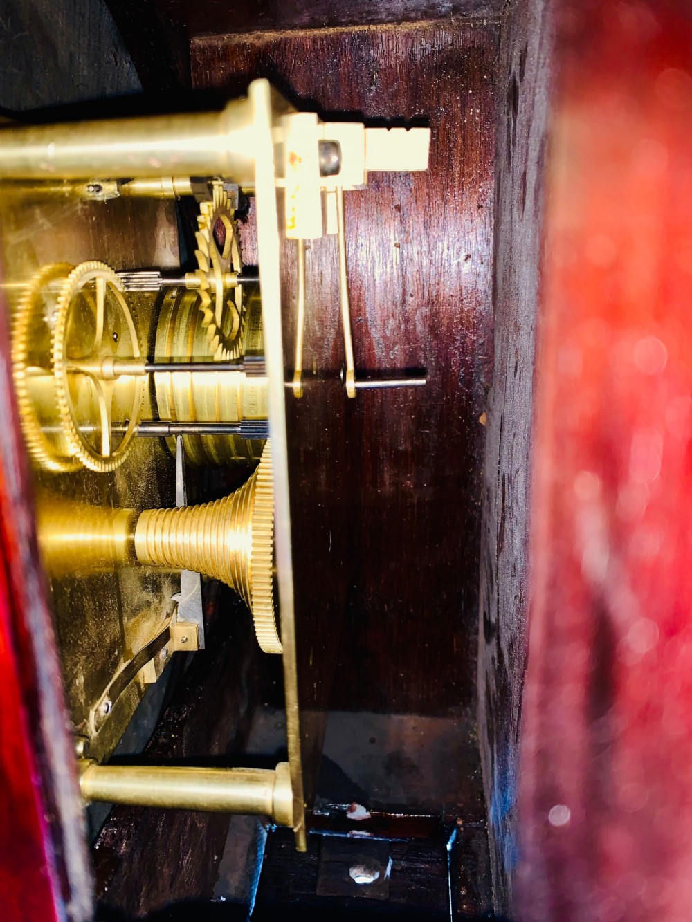 A circular Victorian mahogany fusee dial wall clock featuring a brass bezel and white face with Roman numerals. View XI