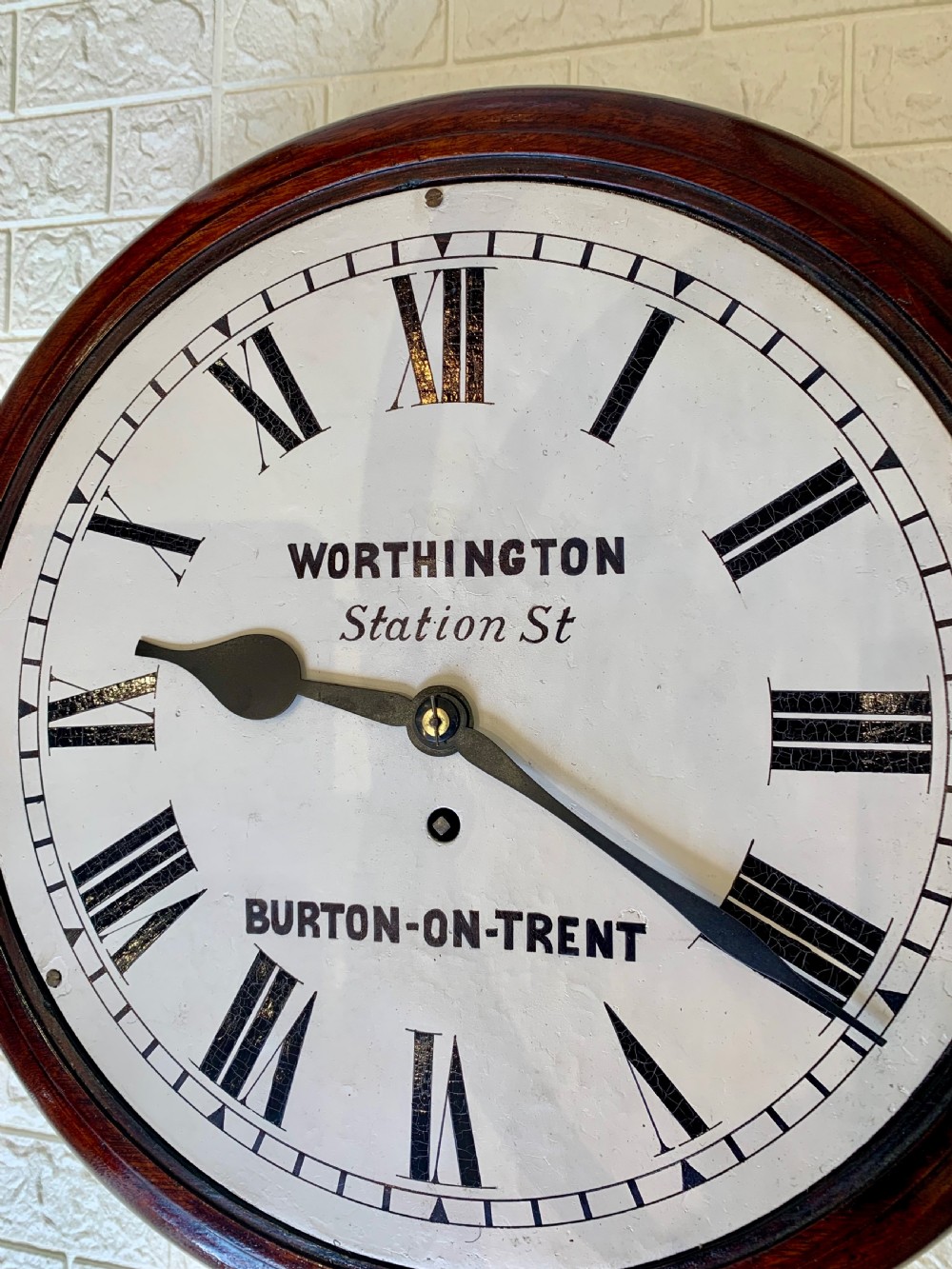 A circular Victorian mahogany fusee dial wall clock featuring a brass bezel and white face with Roman numerals. View XIII