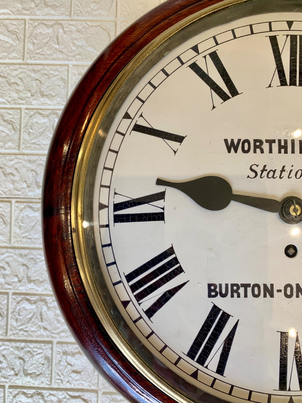 A circular Victorian mahogany fusee dial wall clock featuring a brass bezel and white face with Roman numerals. View XIV