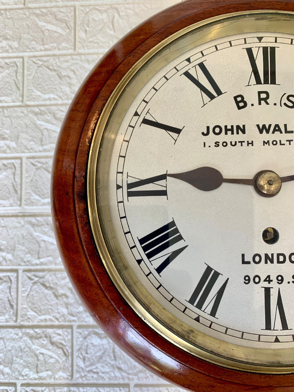 An antique circular mahogany wall clock featuring a cream dial with black Roman numerals and British Railways lettering, framed by a brass bezel. View VI