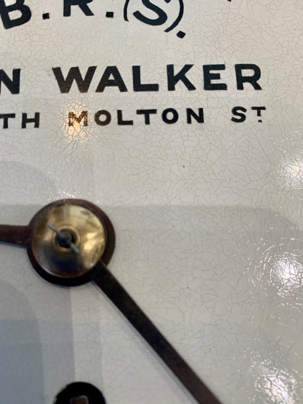 An antique circular mahogany wall clock featuring a cream dial with black Roman numerals and British Railways lettering, framed by a brass bezel. View XV
