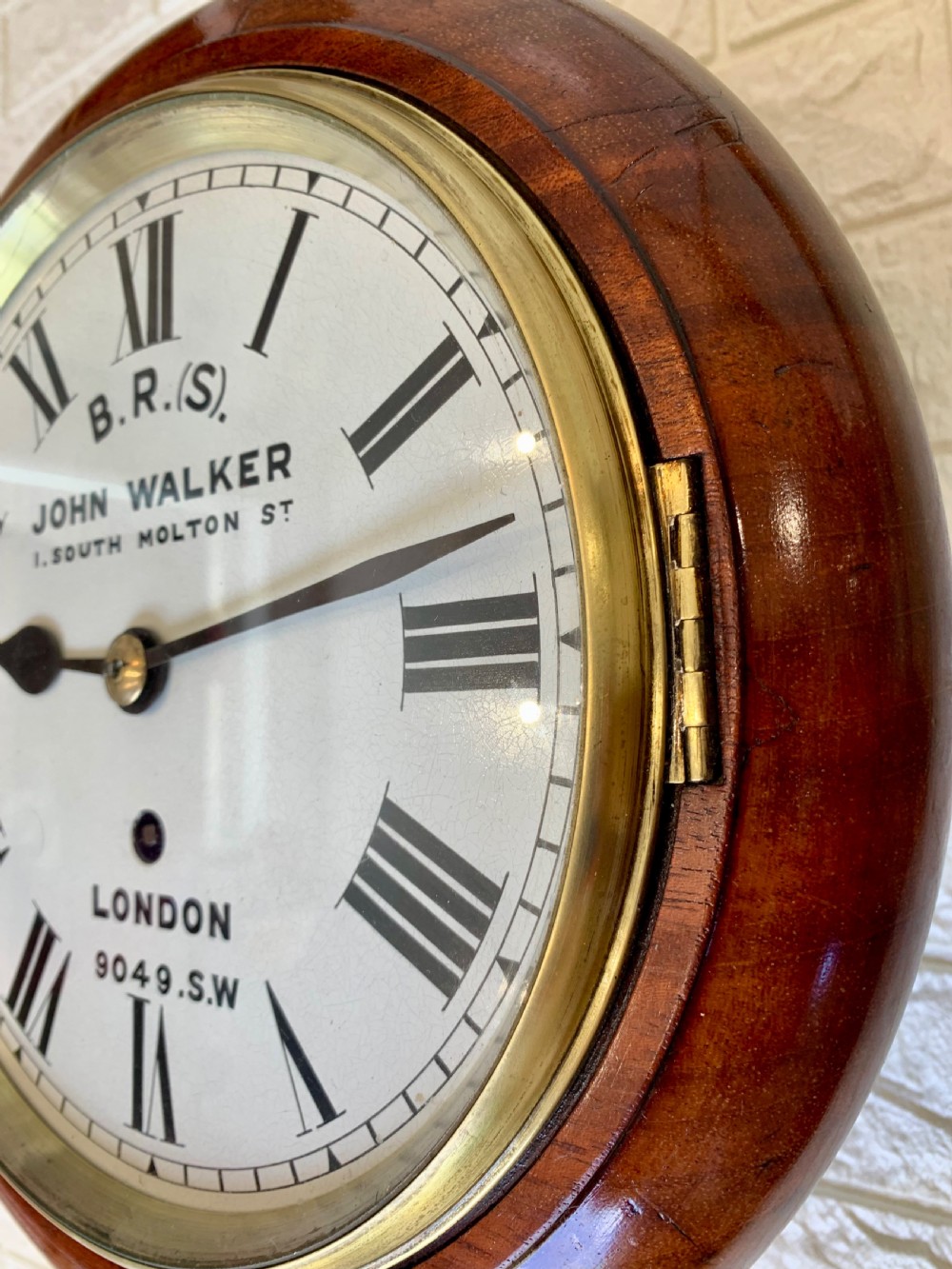 An antique circular mahogany wall clock featuring a cream dial with black Roman numerals and British Railways lettering, framed by a brass bezel. View XVIII