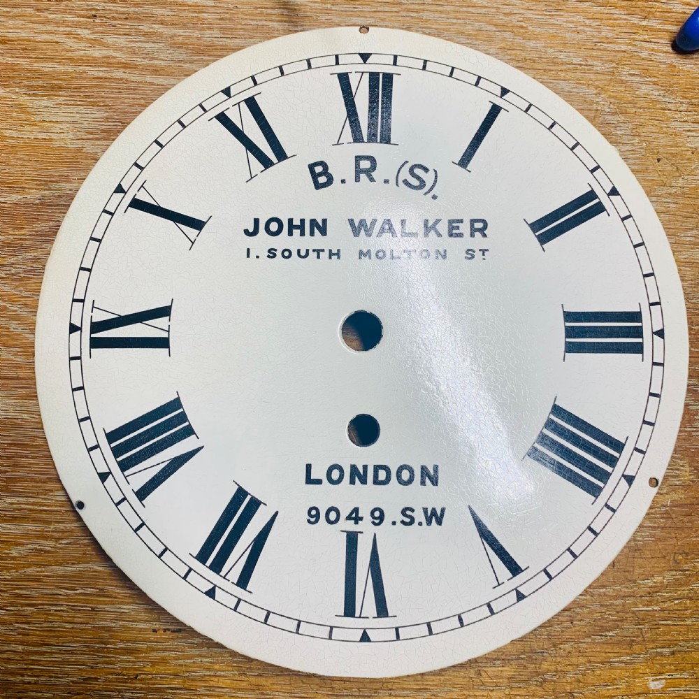 An antique circular mahogany wall clock featuring a cream dial with black Roman numerals and British Railways lettering, framed by a brass bezel. View XX