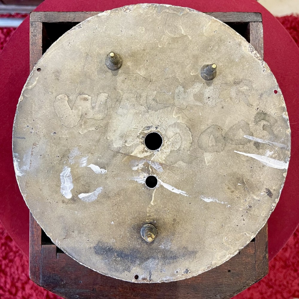An antique circular mahogany wall clock with a brass-hinged glass bezel, white dial featuring Roman numerals, and black markings reading LMSR John Walker London. View XVI